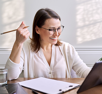 Professional Development - women at desk with pencil in her hand